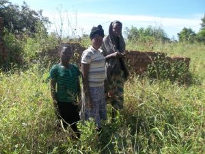 Some of the children outside their ruined home