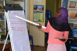 Muslim girl explaining something on flipchart