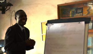 Man laughing next to flipchart