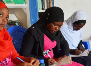 Three Muslim girls writing